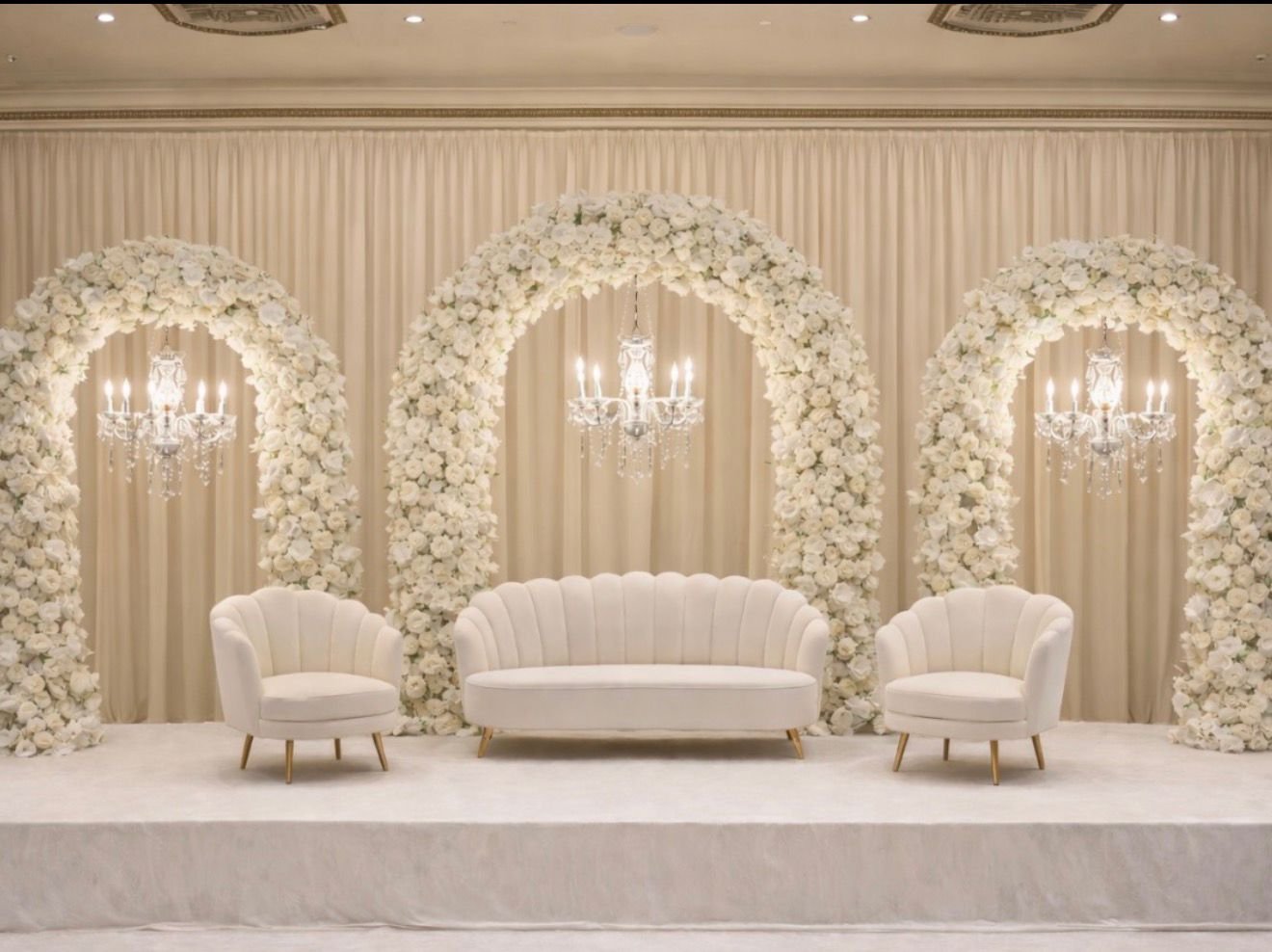 Elegant white floral wedding arch with roses and greenery